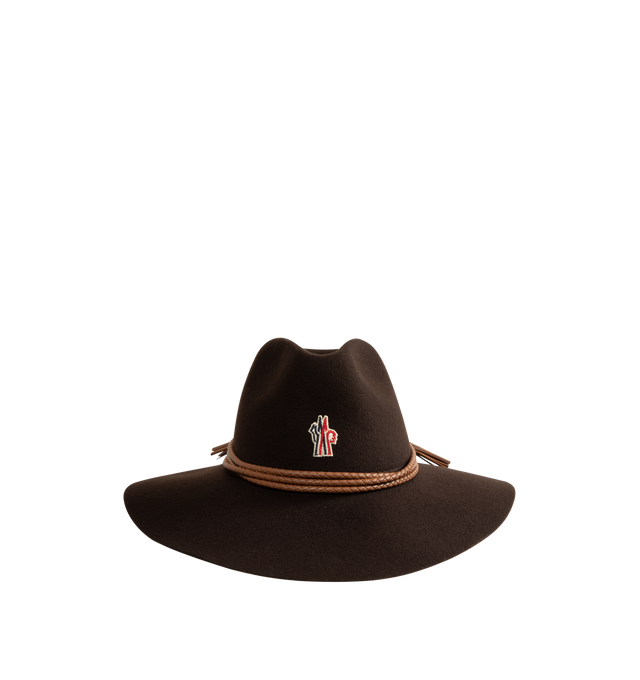 Image 1 of 2 - BROWN - Moncler Grenoble One Size Wool Wide Brim Hat is crafted from wool felt and features a structured wide-brim silhouette inspired by western mountain codes. This refined cold-weather accessory is finished with braided leather cording accented by tassel details. Main Material: 100% Wool. Secondary Material: Cow Leather. One-Size: measures approx 20" in diameter. Made in Italy. 