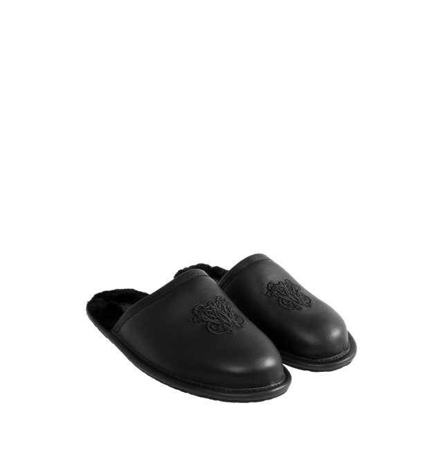 Image 2 of 4 - BLACK - UGG x Willy Chavarria Leather Hotel Slippers are crafted from black leather and feature a luxury reinterpretation of the classic hotel slipper silhouette. Designed with Chavarria's crest embroidered, and lined with UGG's signature plush sheepskin for exceptional comfort. Main Material: Leather. Lining: Sheepskin. Unisex style in men's sizes. 