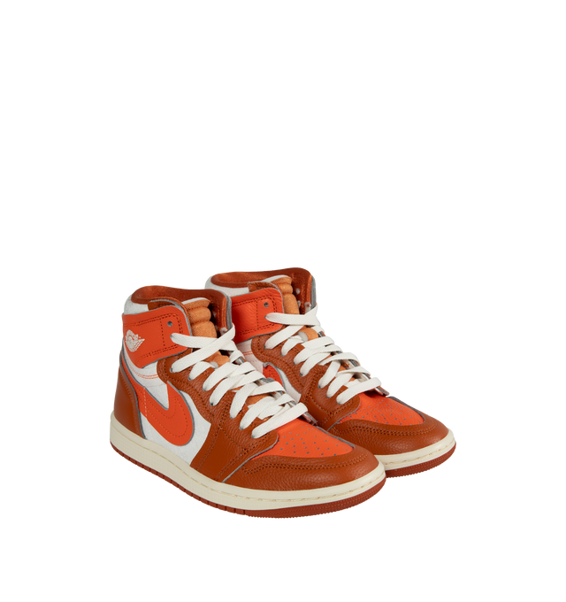 Image 2 of 5 - ORANGE - AIR JORDAN 1 HIGH METHOD OF MAKE features a real and synthetic orange and white color-blocked leather in upper, encapsulated Nike Air unit, rubber in the outsole, wings logo on collar, embroidered Swoosh logo and Jumpman on tongue. 