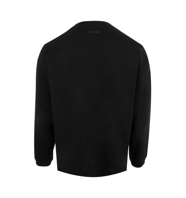 Image 2 of 2 - BLACK - Fear of God Essentials Heavyweight T-Shirt has long sleeves, a crew neck, dropped shoulders, a brand graphic, rib-knit collar and cuffs, and a rubberized brand label. 100% cotton. Made in Viet Nam.  