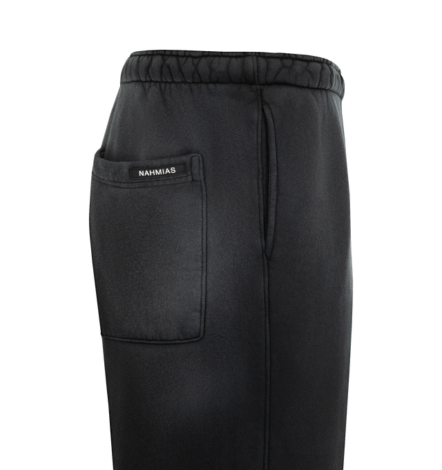 Image 3 of 3 - BLACK - NAHMIAS Aged Wide Sweatpants featuring elastic waist with drawstring, natural faded vintage appearance, side pockets, loose fit and bungee cord at hem. 100% cotton.  