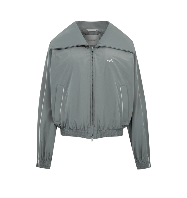 Image 1 of 3 - GREY - BALENCIAGA High Collar Tracksuit Jacket featuring techno cotton poplin, a long high stand up collar, double-ended zip fastening, dropped shoulders, reflective piping, 2 zipped slash pockets, gathered cuffs and waistline and reflective effect artwork printed on the chest. 50% cotton, 50% polyamide. Lining: 100% polyester.  Made in Italy.  