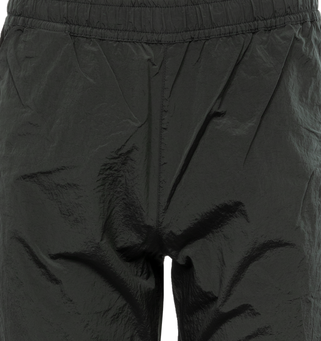 Image 4 of 4 - GREEN - STONE ISLAND Regular Fit Sweatpants featuring valet stand hand pockets with zipper closure inner tape edging, one patch pocket on back with horizontal zipper closure topped with nylon tape, Stone Island badge on the left leg, elasticized leg bottom and elasticized waistband with inner drawstring. 100% polyamide/nylon. 