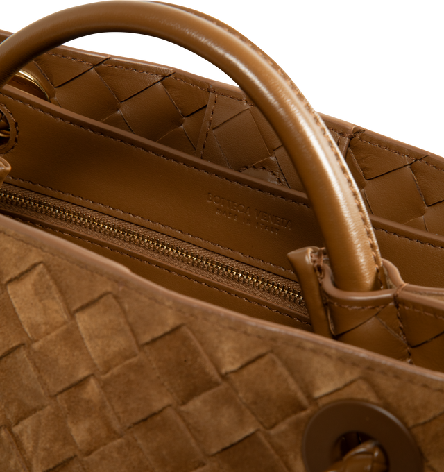 Image 4 of 4 - BROWN - Bottega Veneta Women's Andiamo Small Intrecciato-Suede Top Handle Bag is crafted from supple suede and showcases the houses signature Intrecciato weave. Detailed with gold-tone hardware and the collections signature knot detail, this versatile design features a top handle, a sliding shoulder strap, and a magnetic closure. The thoughtfully organized interior includes one slip pocket, one zip pocket, and two compartments for everyday essentials. Dimensions: 24.8 x 20.3 x 10.2 cm / 9.75  
