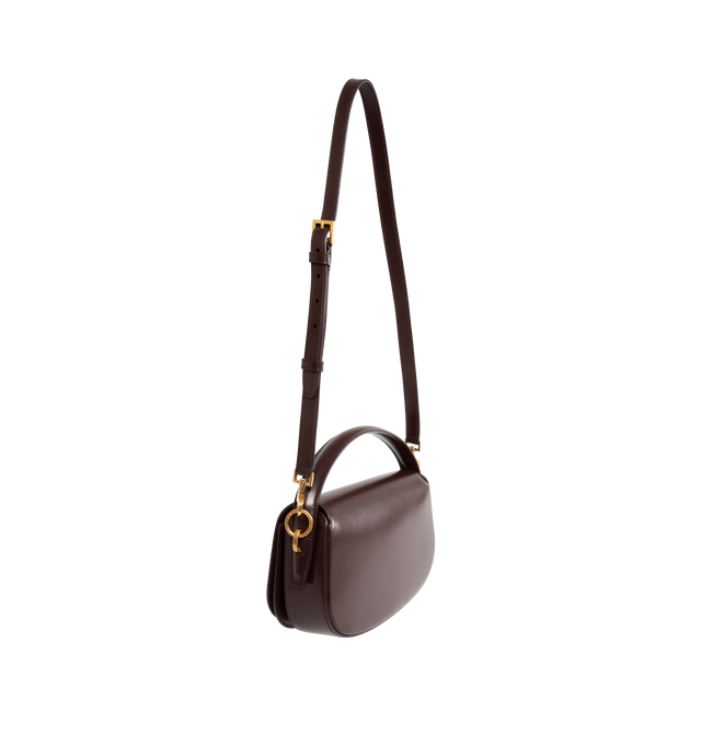 Image 2 of 3 - BROWN - Saint Laurent half-moon shoulder bag in calfskin with a gently polished finish. Features a flap with pivoting Cassandre closure, one flat pocket inside and an adjustable and detachable swivel-hook strap for bespoke carry options.  Calfskin with leather lining, bronze-tone hardware. Measures 9.4" X 5.9" X 2" with a 2.4" handle drop and 10.6" strap drop. Made in Italy. 