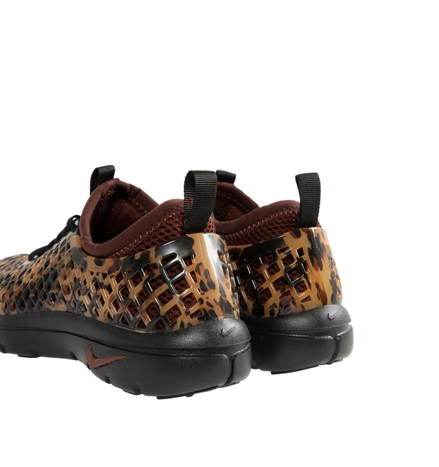 Image 3 of 6 - BROWN - Nike Women's Rejuven8 Run Sneakers feature a black and brown tortoise shell-patterned synthetic upper with a removable mesh bootie and lightly padded collar. Flat laces, heel and tongue pull tabs, a mini Swoosh at the back heel, and Swoosh branding on the sole unit complete the design. ReactX foam provides responsive cushioning, while a rubber outsole offers durable traction. Upper: Synthetic. Bootie: Mesh. Midsole: ReactX Foam. Sole: Rubber. 