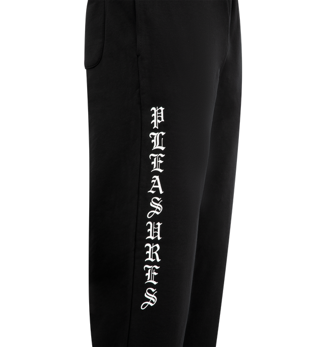 Image 3 of 4 - BLACK - PLEASURES Pipe Sweatpants featuring elastic waist with concealed drawstring, side pockets, loose fit, logo down leg and toggle at hem. Cotton. 