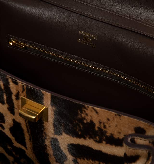 Image 3 of 3 - BROWN - Balenciaga Women's Rodeo Handbag Small is crafted from leopard-print pony hair calfskin and features a structured silhouette with a top handle, removable shoulder strap, aged-gold hardware, and a turn-lock closure. Functional details include a wide front pocket, one main compartment, one inner zip pocket, two flat back pockets, side snaps, four brass feet, and a removable cloche cls with two split rings. Main Material: Leopard-Print Pony Hair Calfskin. Lining: Contrasting Nappa Lambsk 