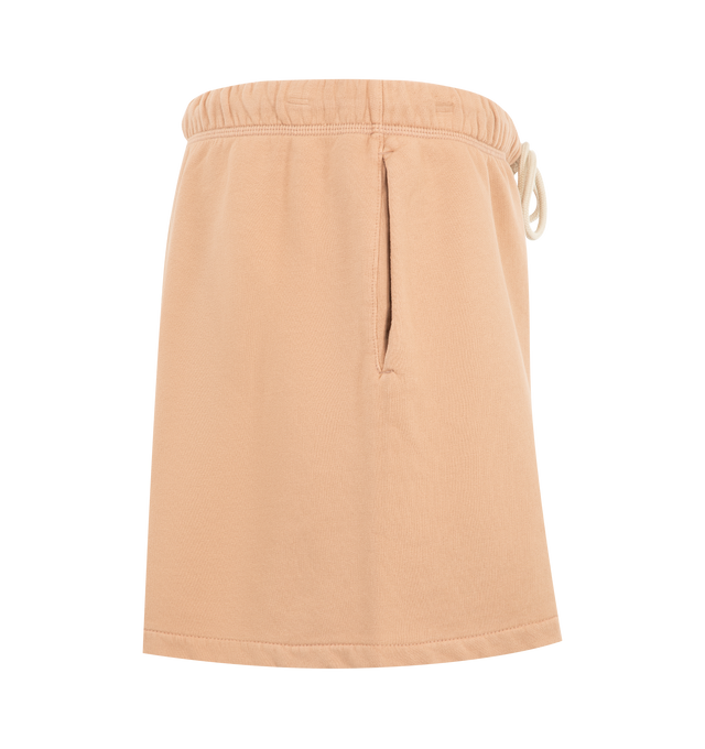 Image 3 of 3 - ORANGE - Fear of God Essentials Womens Classic Sweatshorts are crafted from heavyweight cotton fleece with a pigment-dyed finish. Feature a relaxed classic fit, elasticized waistband with adjustable drawcord and bungee, side-seam pockets, and signature Essentials label. Main Material: 100% Cotton. Imported. 