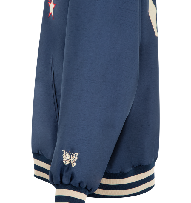 Image 3 of 3 - NAVY - NEEDLES Stadium Jacket in poly shantung featuring embroidered logo to the front, peace sign patch to the rear, contrast-colour long sleeves, press-stud fastening, striped ribbed collar, striped ribbed cuffs and hem, butterfly embroidery at the cuff and two side welt pocket. 100% polyester. 