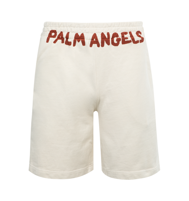 Image 1 of 3 - WHITE - PALM ANGELS Men's butter-colored sweat shorts with vertical pockets and red Palm Angels lettering printed below the elastic waistband at the front. 100% cotton.  
