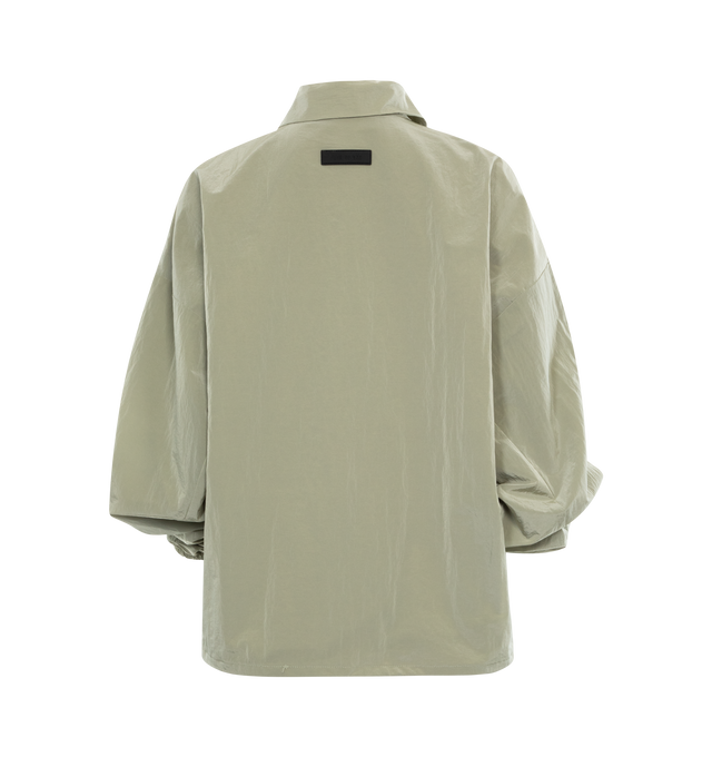 Image 2 of 2 - GREEN - FEAR OF GOD ESSENTIALS Shell Bomber featuring a cropped and rounded silhouette, a classic shirt collar, a rubber brand label at the upper back, a full zipper front closure, and a toggle bungee elastic hem for a customizable fit. 86% woven nylon, 14% spandex. 