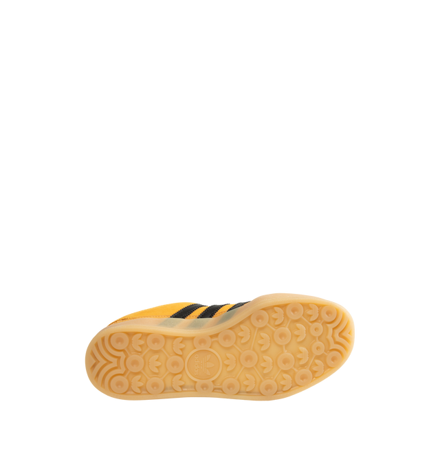 Image 4 of 5 - YELLOW - Adidas Originals x Bad Bunny Men's Gazelle Indoor Shoes feature the latest release from the ongoing adidas Originals by Bad Bunny collaboration, reimagining the iconic Gazelle Indoor silhouette through the artist's distinctive creative lens. Crafted with a premium leather upper, this statement sneaker combines heritage terrace style with contemporary design details, while a textile lining enhances comfort and a durable gum outsole provides everyday traction. Main Material: Leather Up 