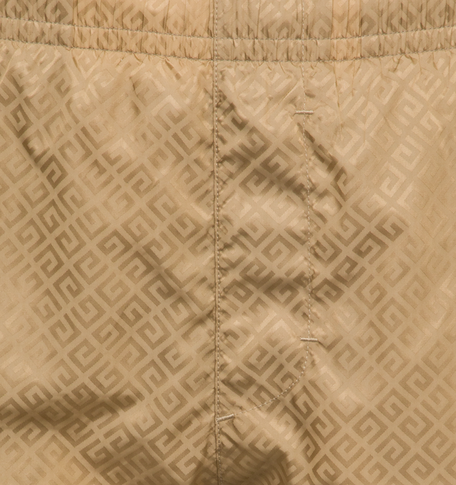 Image 4 of 5 - BROWN - GIVENCHY Long Swim Shorts featuring recycled synthetic fiber, elastic waist, diagonal 4G pattern all-over, small GIVENCHY signature on the left leg, on the front, two side pockets and one back pocket. 100% polyamide. 