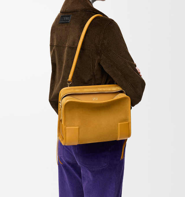 Image 3 of 16 - YELLOW - Loewe Women's Amazona 180 Medium Bag is crafted from suede and calf leather and features a relaxed silhouette with a single toron top handle, a concealed magnetic closure, and removable shoulder and crossbody straps. Designed with two compartments, an internal flat pocket, and a side D-ring for personalization, this versatile style can be carried by hand, over the shoulder, or crossbody. Suede lining and embossed LOEWE branding complete the design. Main Material: Suede/Calf Leather. 