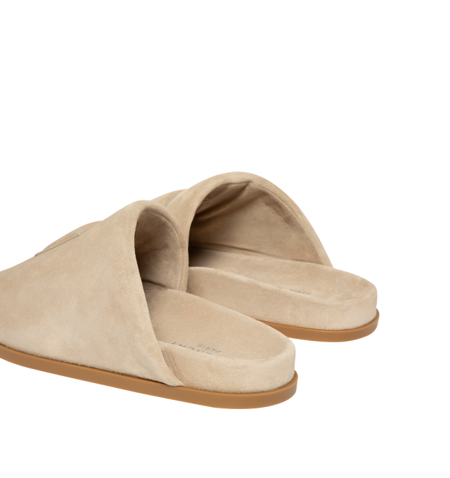 Image 3 of 5 - NEUTRAL - Givenchy Puffy Mules in Suede are crafted from supple calfskin suede and feature the house's signature Puffy silhouette with an asymmetric, slip-on design. Designed with a tonal padded label accented by a silvery Givenchy Paris logo, a branded leather insole, and a raised Givenchy signature beneath the sole, the mules combine comfort with a refined contemporary aesthetic. Main Material: 100% Calfskin Leather. Lining: 100% Calfskin Leather. Made in Italy. 