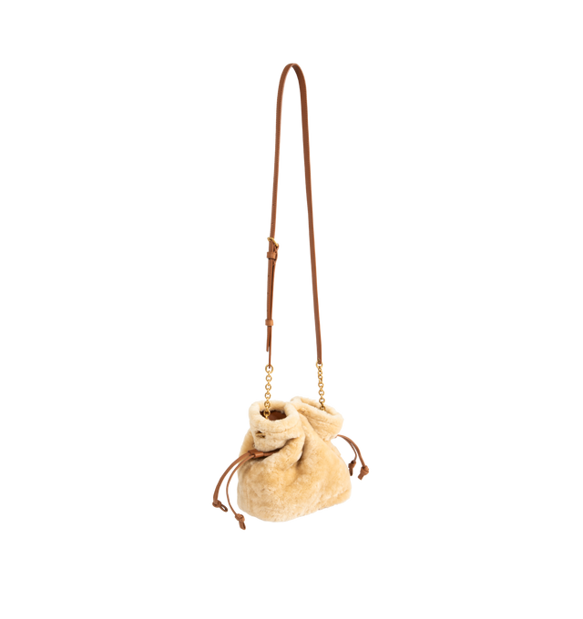 Image 2 of 3 - NEUTRAL - Saint Laurent Women's Jamie Mini Shoulder Bag is crafted from dyed shearling in natural beige and brick with a leather lining. The compact silhouette features bronze-tone Cassandre hardware, an open top with drawstring and magnetic closures, and a detachable, adjustable chain-and-leather strap for shoulder or crossbody carry. Main Material: Dyed Shearling. Lining: Leather. Dimensions: 12 x 15.2 cm / 4.7 x 6 in. Made in Italy. 