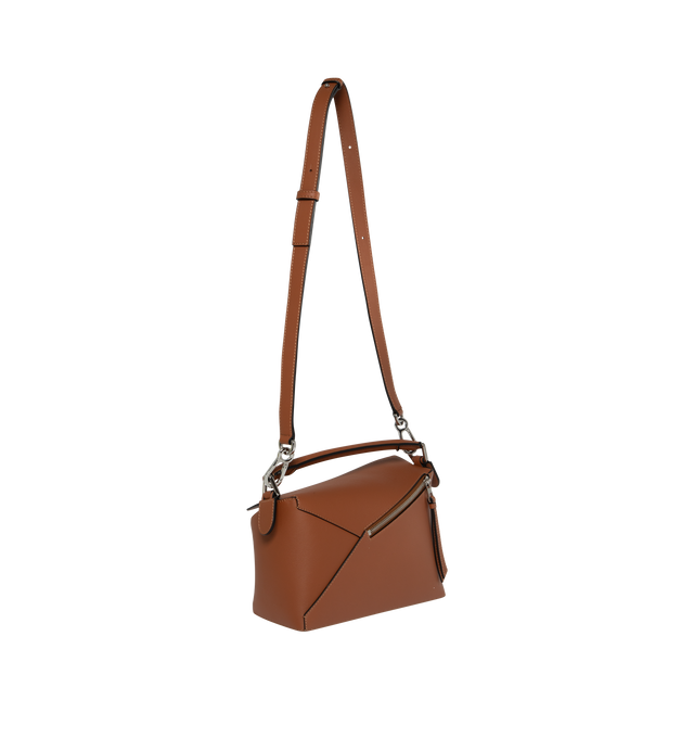Image 2 of 3 - BROWN - LOEWE Puzzle Bag's cuboid shape and precise cutting technique create distinctive geometric lines. Shoulder, crossbody, top handle or clutch carry. Bag measures 9.4" wide x 6.5" tall. Detachable and adjustable shoulder strap up to 45" long.  Zip closure with calfskin pull, exterior zip rear pocket and one internal slip pocket, herringbone cotton canvas lining and embossed anagram. 100% calfskin leather. 