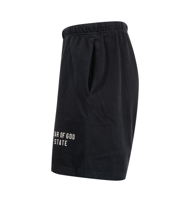 Image 3 of 3 - BLACK - Fear of God Essentials Heavy Jersey Soccer Shorts have an elastic drawstring waist, side pockets, a brand label, and brand screenprinting. 80% cotton, 20% polyester. Made in Vietnam. 