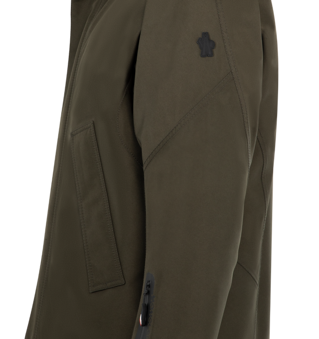Image 3 of 3 - GREEN - MONCLER GRENOBLE Lambir Jacket featuring lightweight nylon, attached drawcord hood, long-sleeves with tab cuffs, snap button, zipper closure, zipper sleeve pocket and waist pockets. 100% polyamide. Lining: 89% polyester, 11% elastane.   