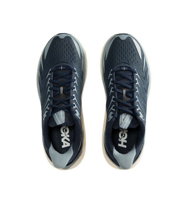Image 5 of 5 - BLUE - Hoka Men's Clifton UTL is crafted with a breathable mesh upper and features raised PU-molded overlays that create a textured exoskeleton for added durability and support. Built on the brands popular Clifton 8 platform, this lifestyle sneaker is designed with reflective laces and webbing details, a plush CMEVA midsole, and a Durabrasion rubber outsole for everyday comfort and traction. Upper: Mesh with PU-Molded Overlays. Midsole: CMEVA. Outsole: Durabrasion Rubber. Details: Reflective  