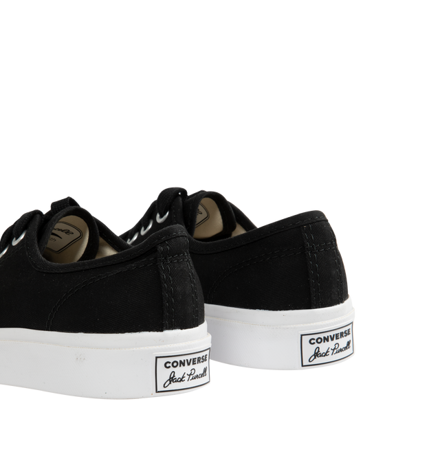 Image 3 of 5 - BLACK - Converse Jack Purcell Sneakers in a refined, sporty low top style. Featuring durable canvas upper, layers of comfort cushioning with a wedge helps provide optimal support, signature smile branding on the toe cap, and rubber sole with herringbone details helps provide traction. Unisex styke in men's sizes. 