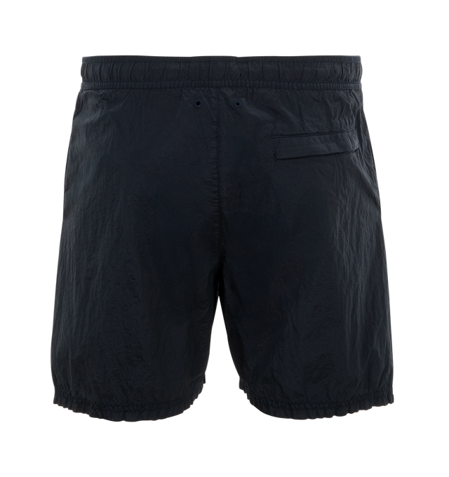 Image 2 of 3 - NAVY - Stone Island regular-fit mid-length swim trunks made from a new responsible iridescent Nylon Metal fabric with ECONYL regenerated yarns, featuring Velcro pockets and inner mesh lining. Garment dyed with double-dye procedure. External Fabric: 100% Polyamide / Nylon. Lining: 100% Polyamide / Nylon. Made in Indonesia. 