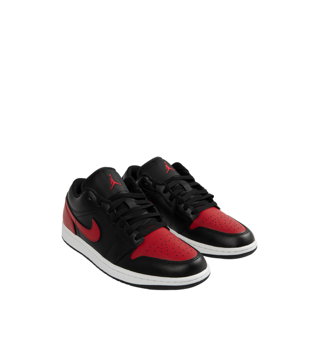 Image 2 of 5 - BLACK - Jordan Air Jordan 1 Low Sneakers are a lace-up style with real and synthetic leather uppers, Nike Air technology impact cushioning, padded collars, rubber soles, and wing logos on the heels.  