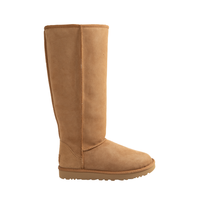 Image 1 of 4 - BROWN - Ugg Women's Classic Ultra Tall Boot is a sky-high version of the iconic style. Featuring a 15-inch shaft height, plush sheepskin lining, and an ultra-lightweight rubber outsole for comfort. Main Material: 17mm Twinface Sheepskin. Lining: 17mm Sheepskin. Insole: 17mm Sheepskin. Sole: Sugarcane EVA. Details: Overlock Stitch Seams.  