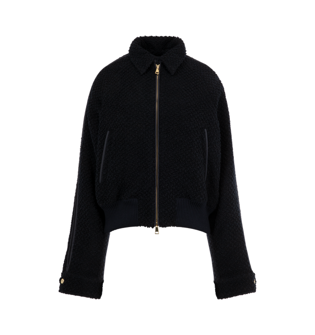 Image 4 of 4 - NAVY - MONCLER Juvigny Hooded Tweed Bomber Jacket featuring piped trims and gold-tone hardware, detachable, adjustable hood, point collar with throat latch, long raglan sleeves with snap cuffs, signature leather logo patch at left sleeve, slip pockets, classic fit, rib-knit hem and two-way zip-front. Virgin wool, polyester, leather. Fill: Down/feather. 