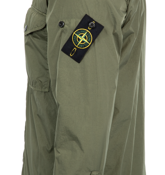 Image 3 of 3 - GREEN - STONE ISLAND Light Outerwear Jacket featuring chest pocket, adjustable snap at cuffs, neck button, Stone Island badge on the left sleeve and two-way hidden zipper fastening. 100% recycled light nylon. 