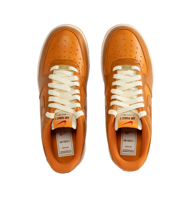 Image 5 of 5 - ORANGE - Nike Air Force 1 '07 LV8 Sneakers are a lace-up style with perforations for ventilation, foam soles, encapsulated Air cushioning, and padded collars.  