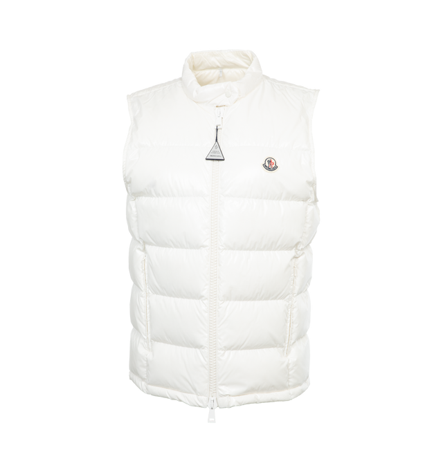 Image 1 of 3 - WHITE - MONCLER Alcibia Puffer Vest featuring shiny patent finish, stand collar, two-way front zip, chest logo patch, sleeveless, side-entry zip pockets, mid-length and slim fit. 100% polyamide/nylon. Padding: 90% down, 10% feather. Made in Romania. 