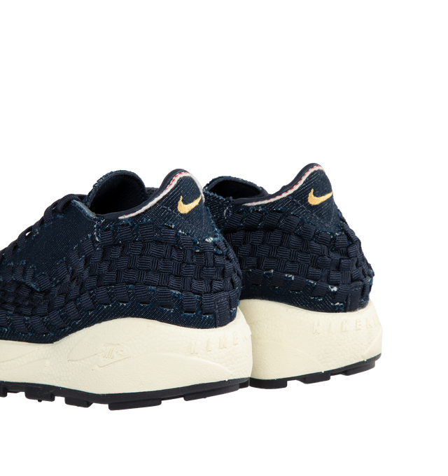 Image 3 of 5 - NAVY - NIKE Air Footscape Woven Sneakers featuring a blue denim colored textile and soft suede upper, asymmetrical woven details, lateral lacing, foam midsole, Nike Air cushioned heel and rubber outsole. 