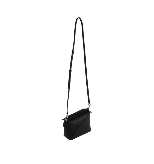 Image 2 of 3 - BLACK - LOEWE Puzzle Bag's cuboid shape and precise cutting technique create distinctive geometric lines. Shoulder, crossbody, top handle or clutch carry. Mini measures 7.1" wide X 4.9" tall. Detachable and adjustable shoulder strap up to 53" long.  Zip closure with calfskin pull, exterior zip rear pocket and one internal slip pocket, herringbone cotton canvas lining and embossed anagram. 100% calfskin leather. 