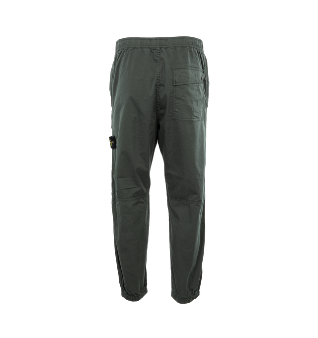 Image 2 of 4 - GREEN - STONE ISLAND Loose-Fit Cargo Pants featuring slanting hand pockets with slanted shaped flap and snap fastening, one patch bellows pocket on the back with shaped flap fixed on one side with a snap on the other side, big patch bellows pocket on the left leg, fixed on one side, snap on the other side, Stone Island badge, elasticized leg bottom and elasticized waistband with inner drawstring. 97% cotton, 3% elastane/spandex. 