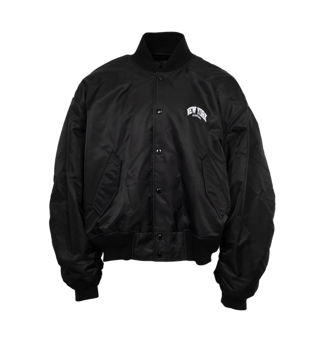 BLACK - BALENCIAGA NY Varsity Jacket featuring light nylon, large fit, snap closure, 2 snap flap pockets at front, ribbed trims and New York with logo embroidered at chest and back. 100% polyamide. Made in Italy.