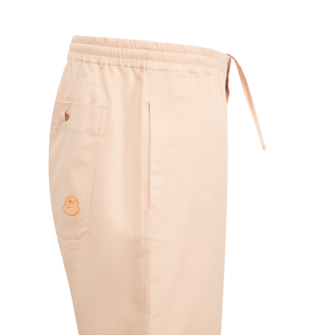 Image 3 of 3 - PINK - Moncler x Gilga Farm Designed by Donald Glover Cotton Gabardine Pants featuring longue saison lining, down-filled, zipper closure with ribbon trim, zipped pockets and logo patch. 74% cotton, 24% lyocell, 2% elastane/spandex. Made in Romania. 