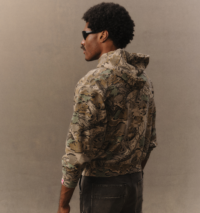Image 5 of 6 - GREEN - Cherry LA Men's Chevron Pullover Hoodie is crafted from custom cotton fleece and features a boxy-fit silhouette with a classic pullover design. Designed with a chest patch, distressed detailing, and a branded label at the cuff, this everyday essential combines a relaxed fit with Cherry LA's signature worn-in aesthetic. Main Material: Custom Cotton Fleece. Made in Los Angeles, California. 