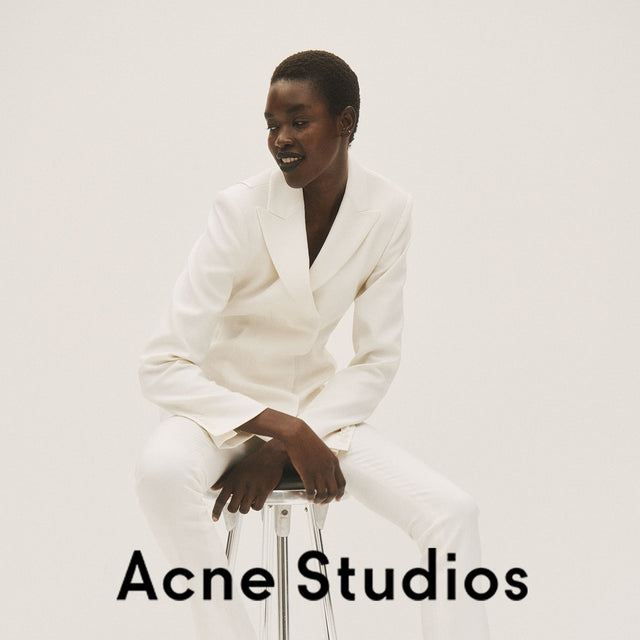 Woman wearing white blazer and pants by Acne Studios 