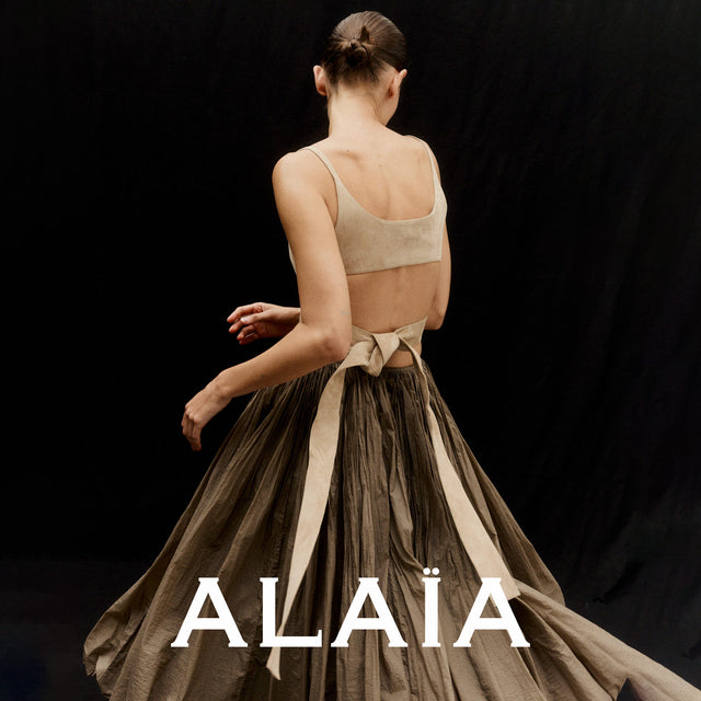 Model wearing a brown Alaia skirt and backless top  