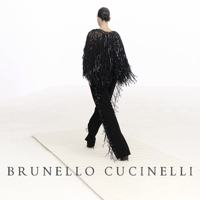 Woman wearing Brunello Cucinelli fringe top and black pants 