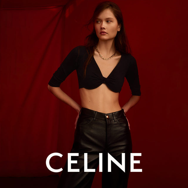 Woman wearing black draped crop top and black leather pants by Celine