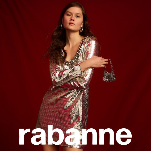 Woman wearing silver sequin mini dress with long sleeves by Rabanne 