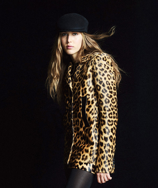 Woman wearing a leopard print coat and skirt by Khaite 