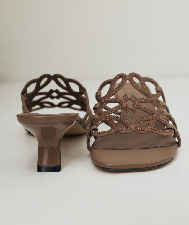 Brown high-heeled sandals with intricate cut-out design by Loewe 
