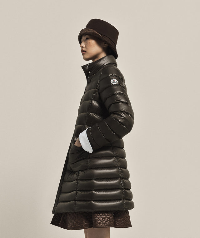 Person wearing a black puffer coat by Moncler 