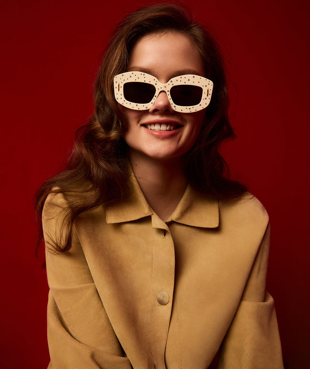 Woman wearing Loewe TURN-UP lightweight suede lambskin jacket and Screen sunglasses crafted in acetate with Swarovski crystal embellishments 