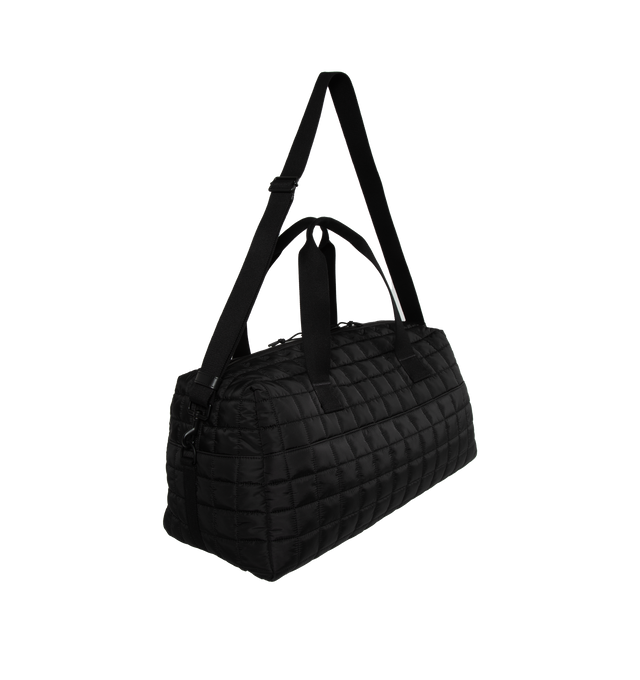 Image 2 of 3 - BLACK - SAINT LAURENT Nuxx Duffle Bag featuring quilted ECONYL, two long top handles, an adjustable and removable shoulder strap with sliding pad, debossed signature on front, two way zipper closure, one exterior pocket and one zip pocket. 19.6 X 9.4 X 9.8 inches. 95% polyamide, 5% metal. 