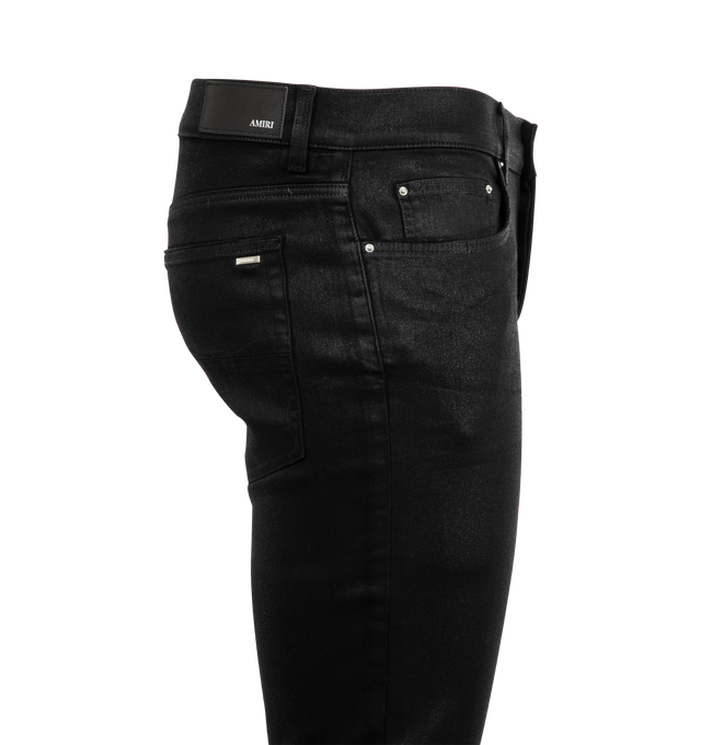 Image 3 of 3 - BLACK - AMIRI Wax MX1 Jeans featuring stretch denim, belt loops, five-pocket styling, button-fly, hand-distressed detailing at front, quilted leather patched at front, leather logo patch at back waistband, logo plaque at back pocket and logo-engraved silver-tone hardware. 92% cotton, 6% elastomultiester, 2% elastane. Made in United States. 